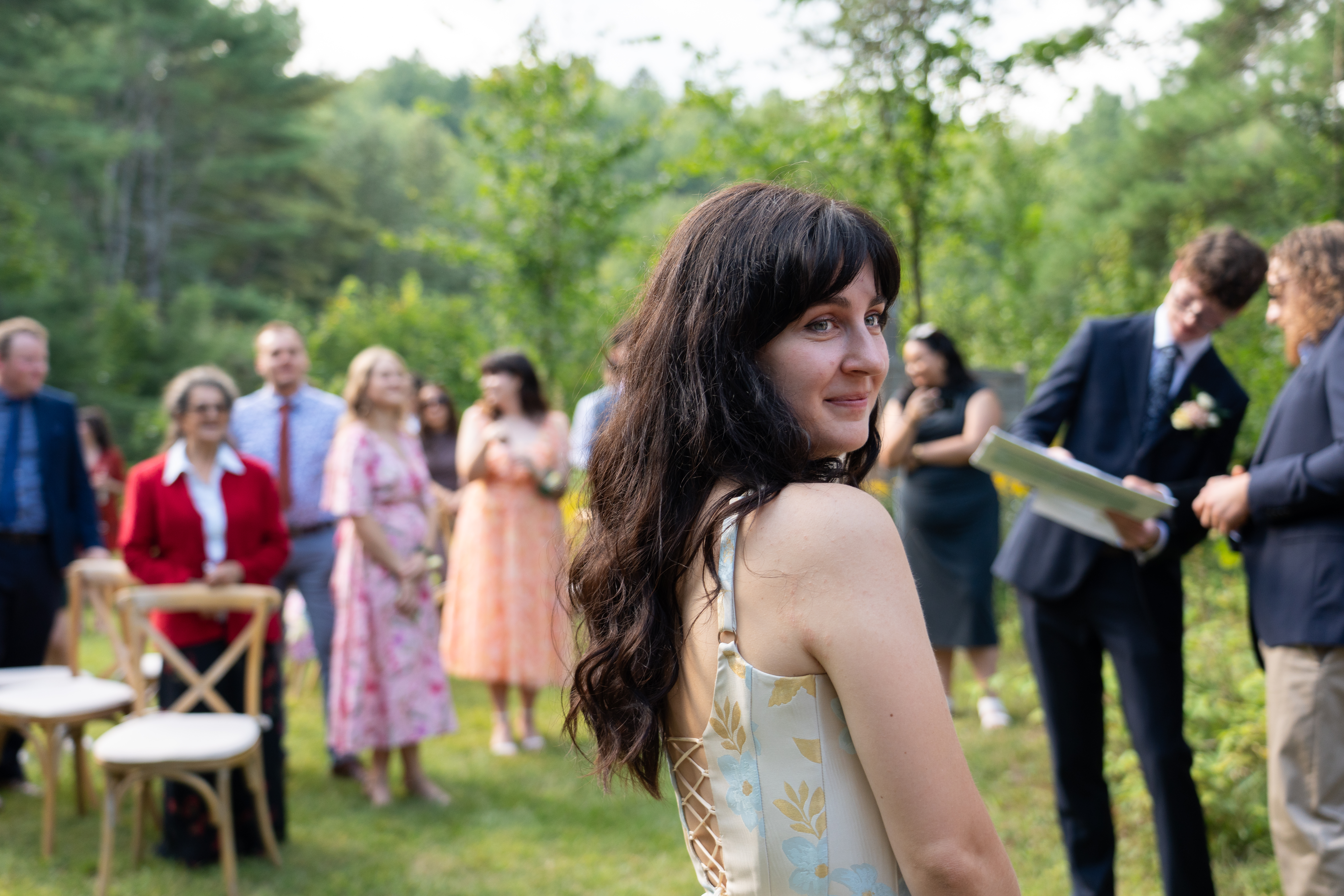 Bride stands in front of her guests, smiling
